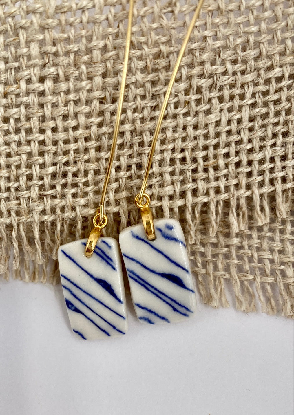 Porcelain geometric hanging earring. Blue organic lines.