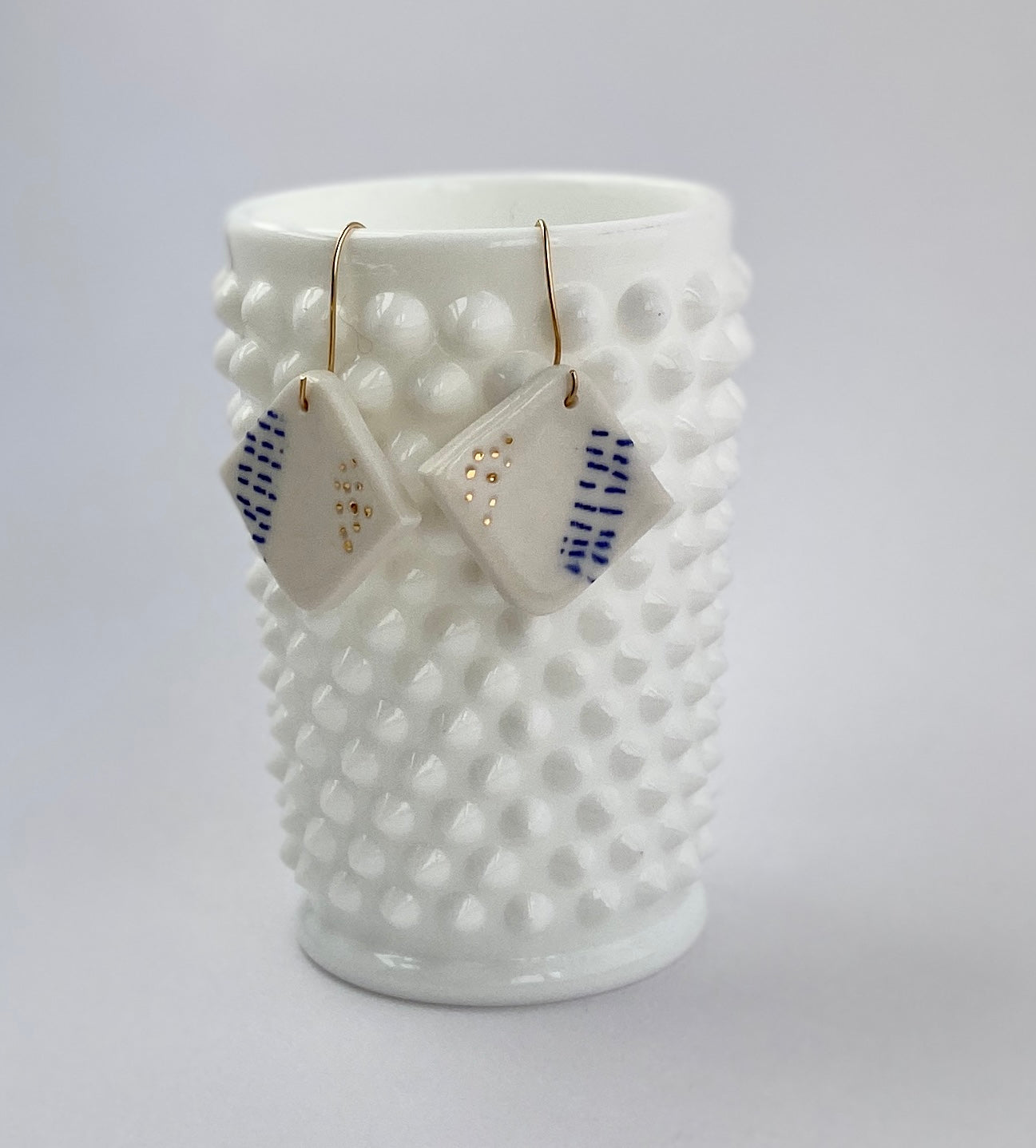 Porcelain geometric earring with 22 karat gold accents.