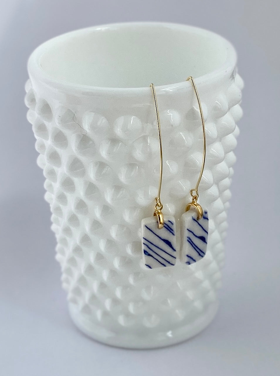 Porcelain geometric hanging earring. Blue organic lines.